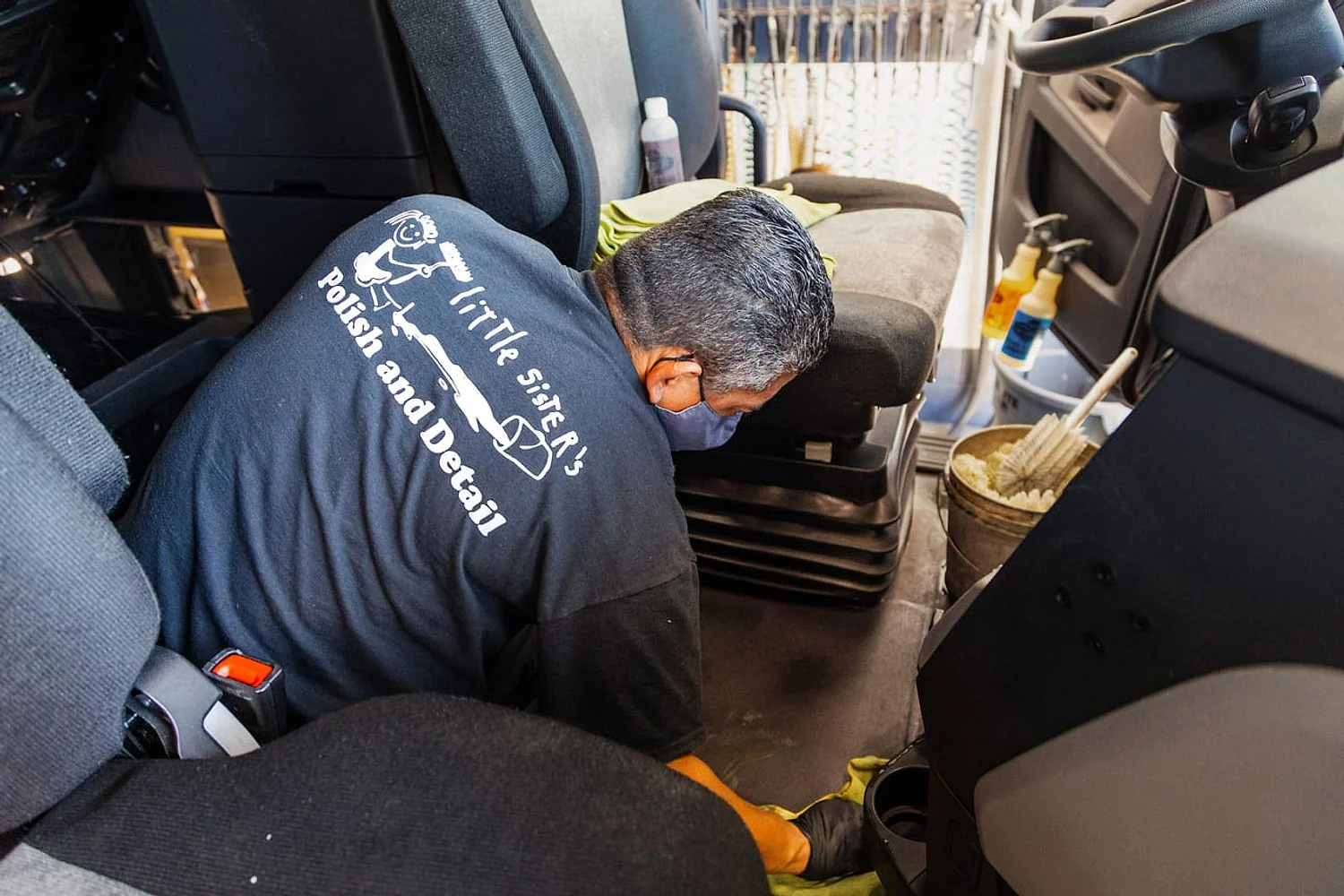 Crew deep cleaning and detailing a truck cab interior