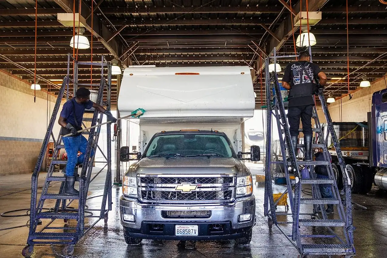 Crew hand treating every panel at Little Sister's Truck Wash